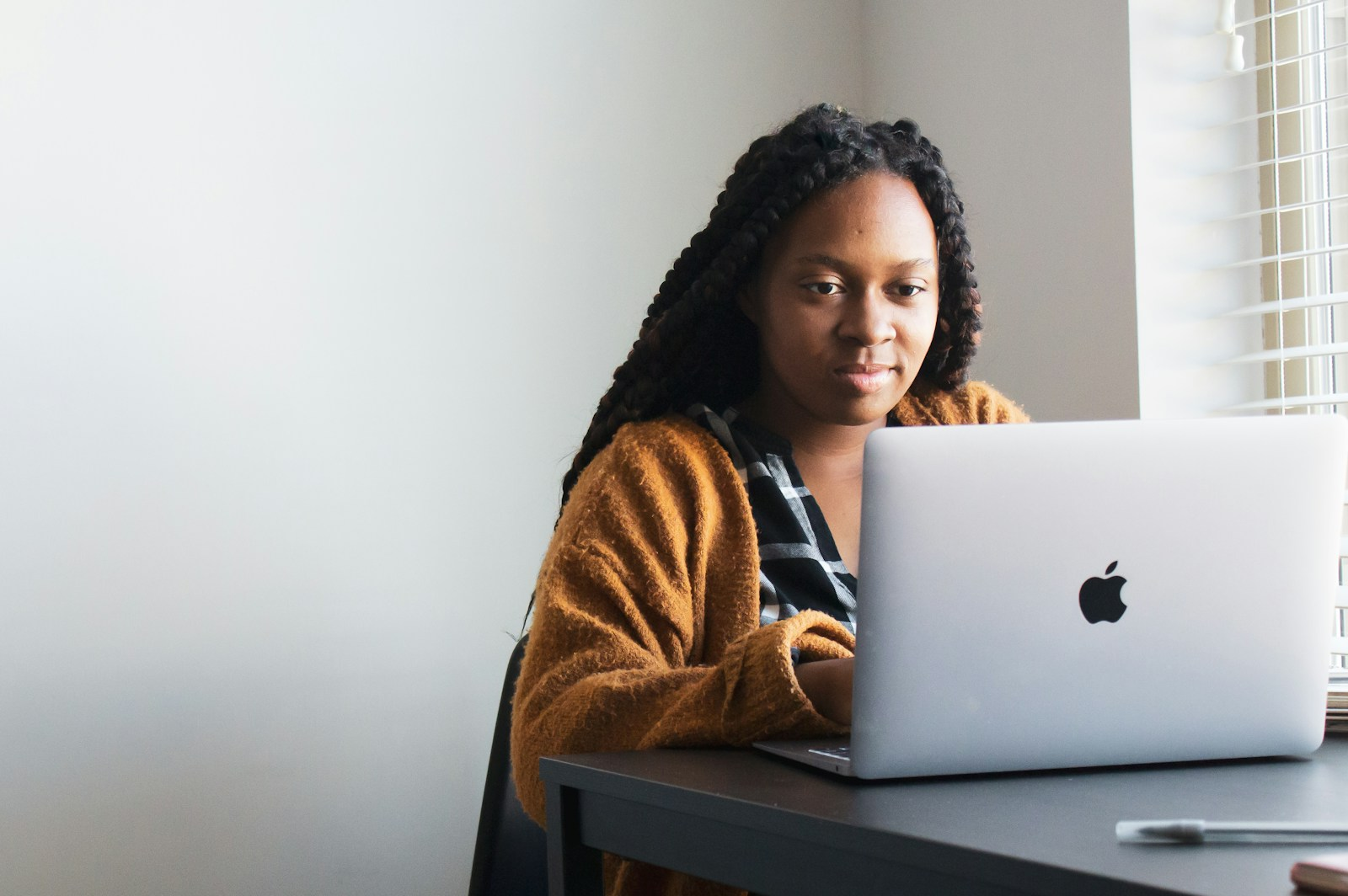 A person working remotely from home at a laptop, illustrating hybrid and remote work in a changing workplace