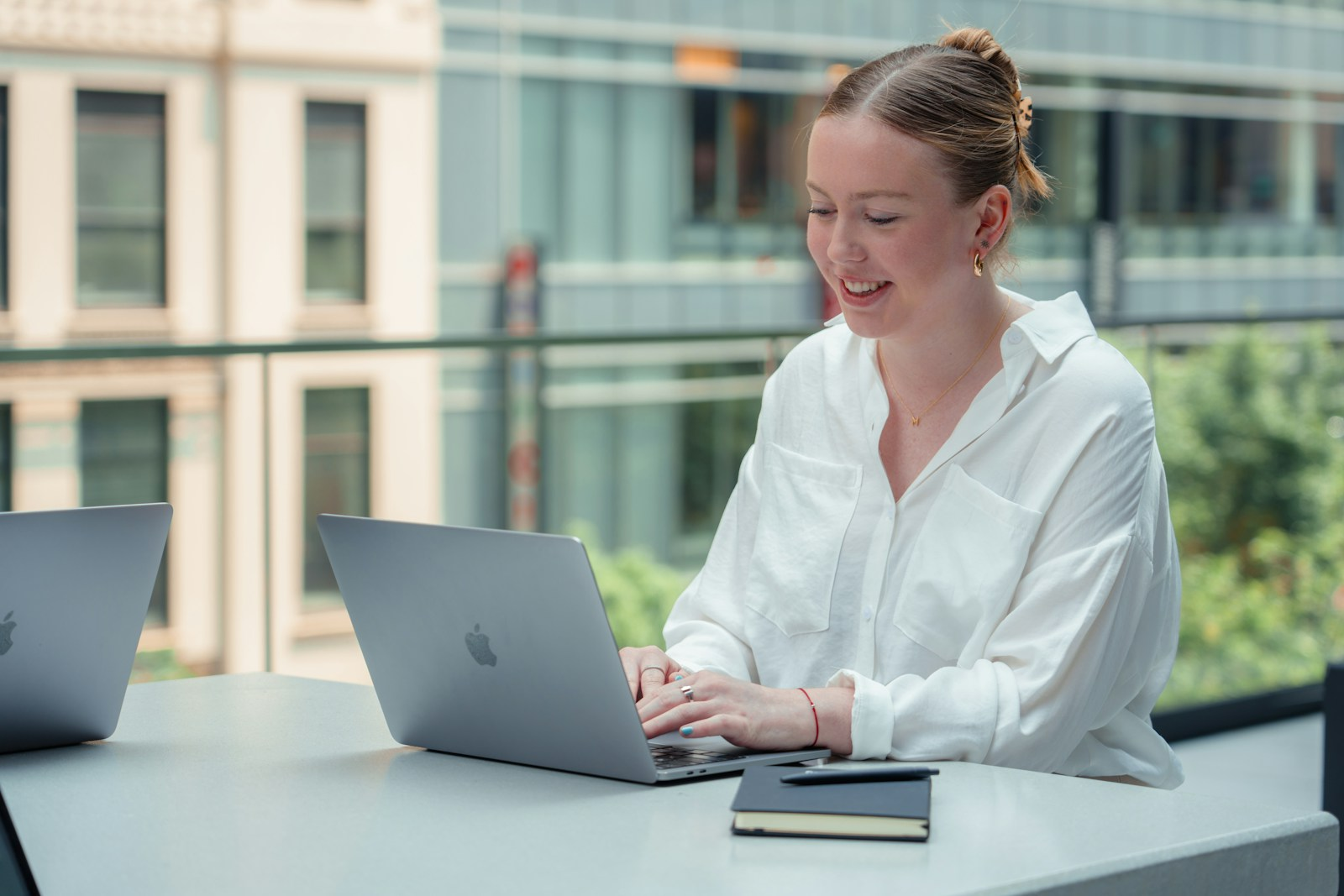 A young professional working at a laptop early in a career, representing the early-career workers most affected in the Stanford Canaries Dashboard data