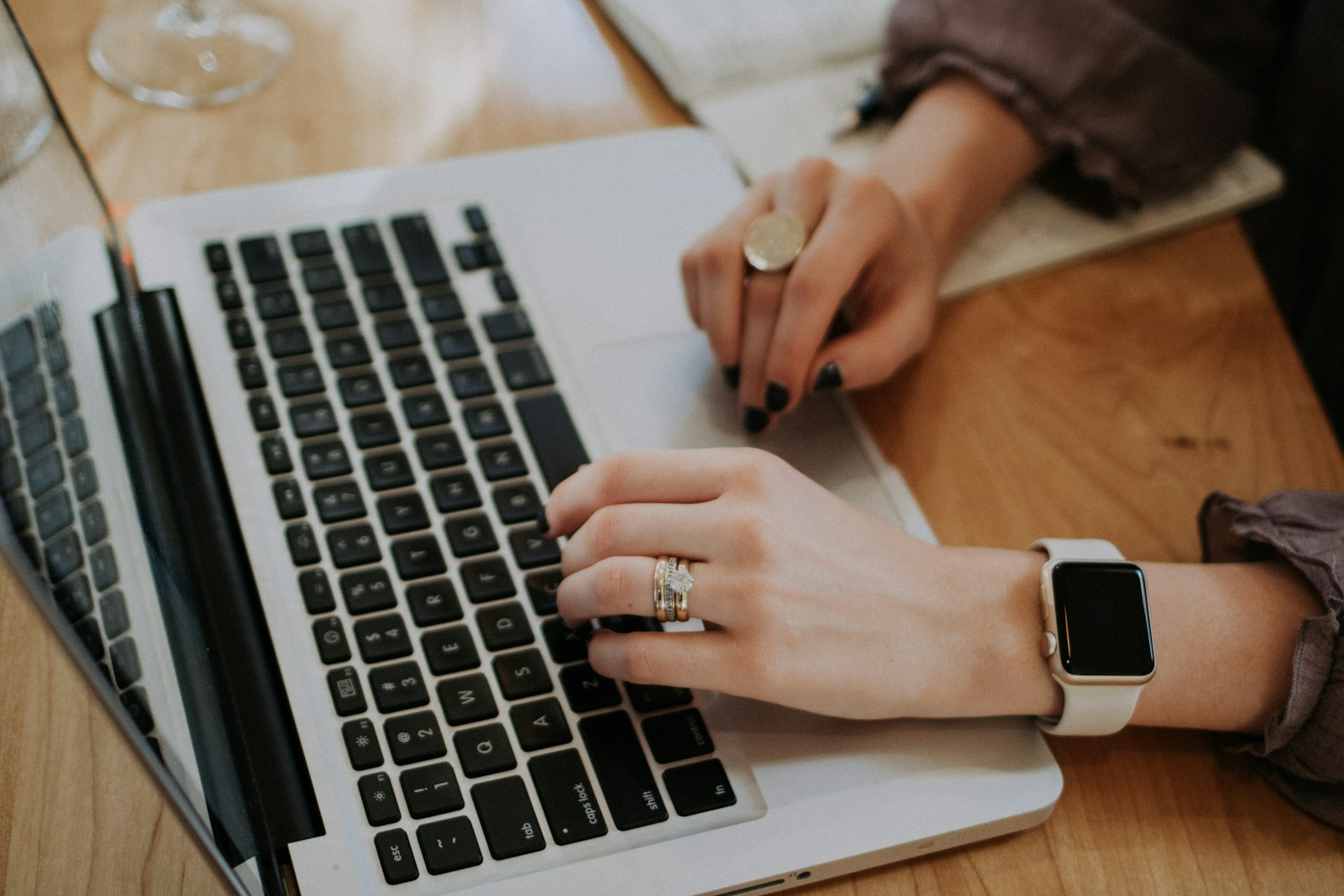 A job seeker typing on a laptop, working on cover letters to get more interviews