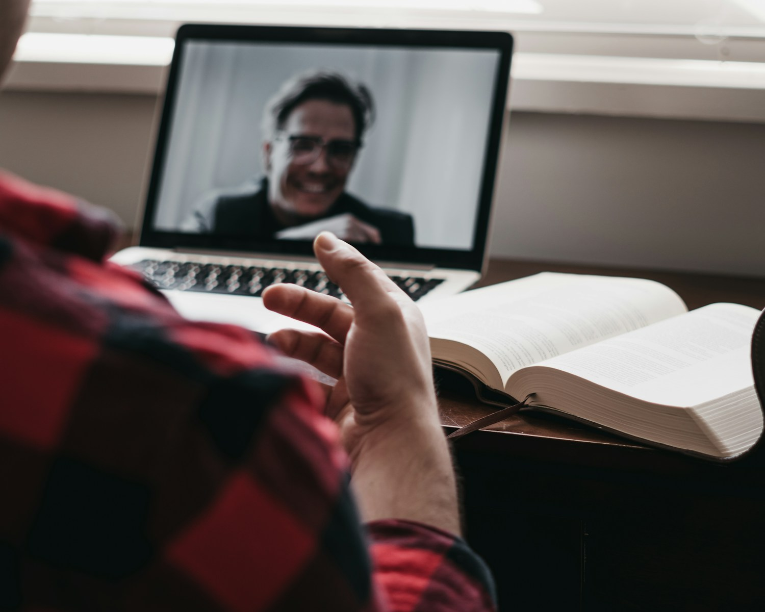 A person taking notes during a video call, representing the communication skills online tutor jobs require