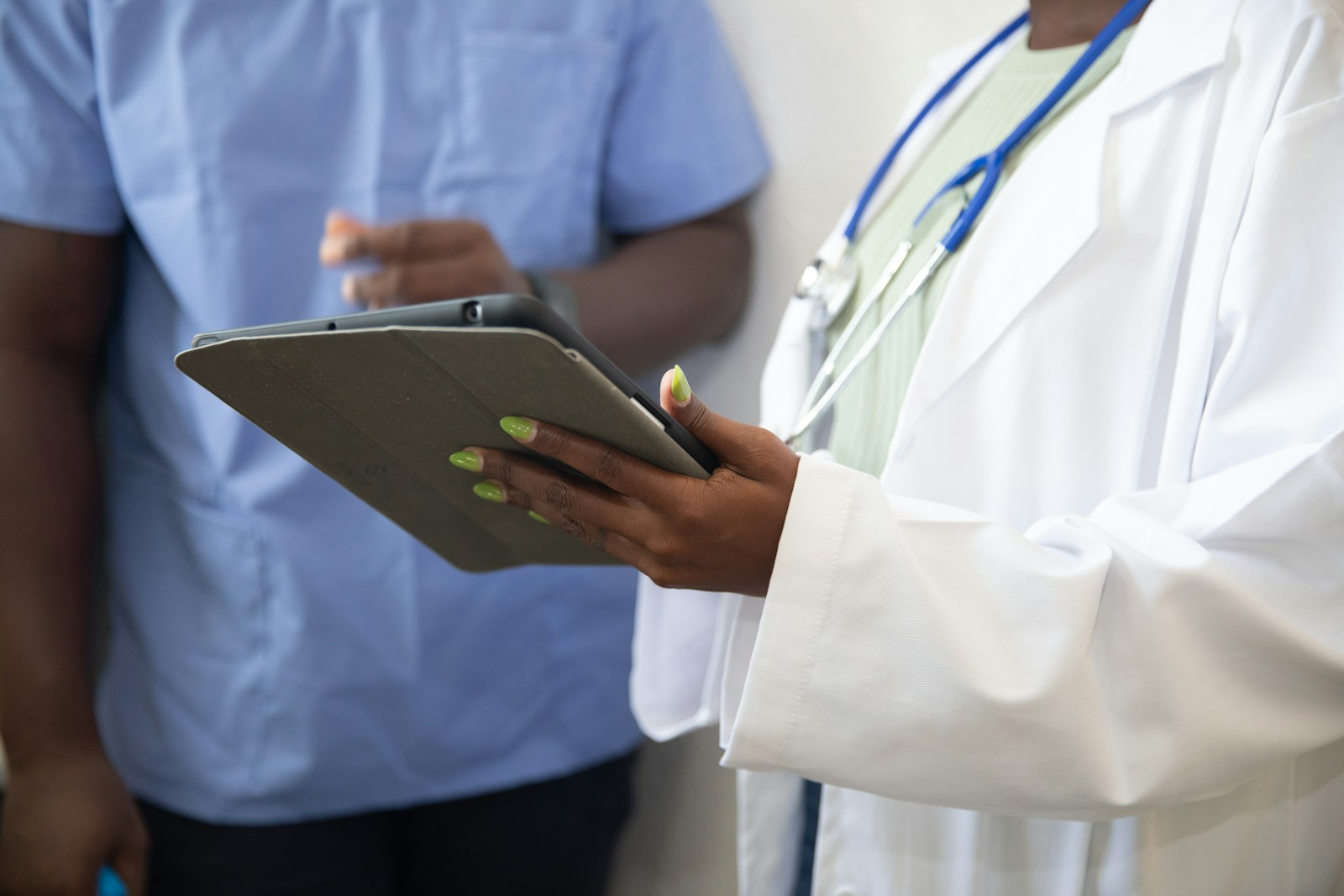 A health information specialist reviewing patient records on a tablet, representing real growth behind the medical transcriptionist boom claim