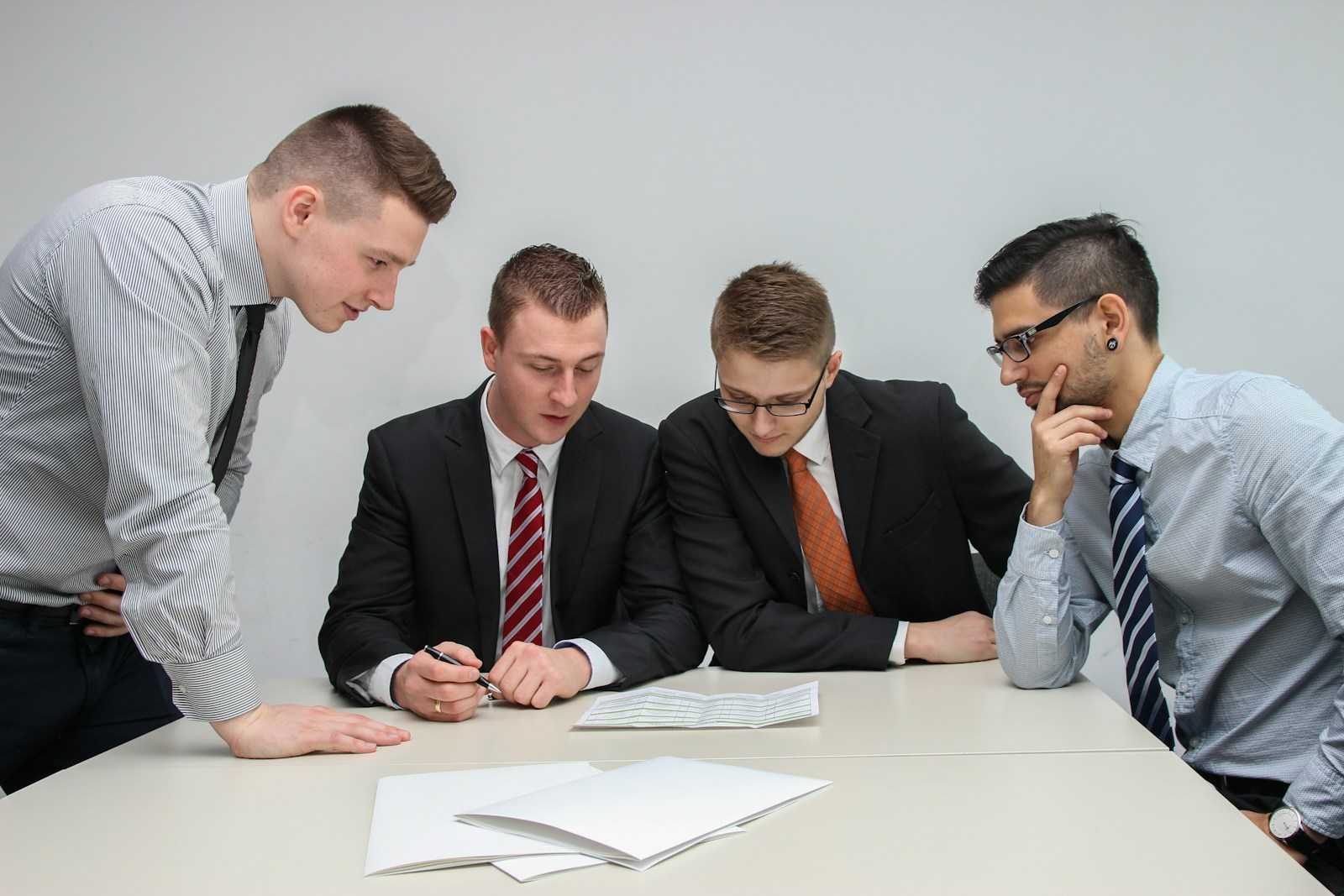 Coworkers in a serious office meeting reviewing documents, representing the at-will employment doctrine