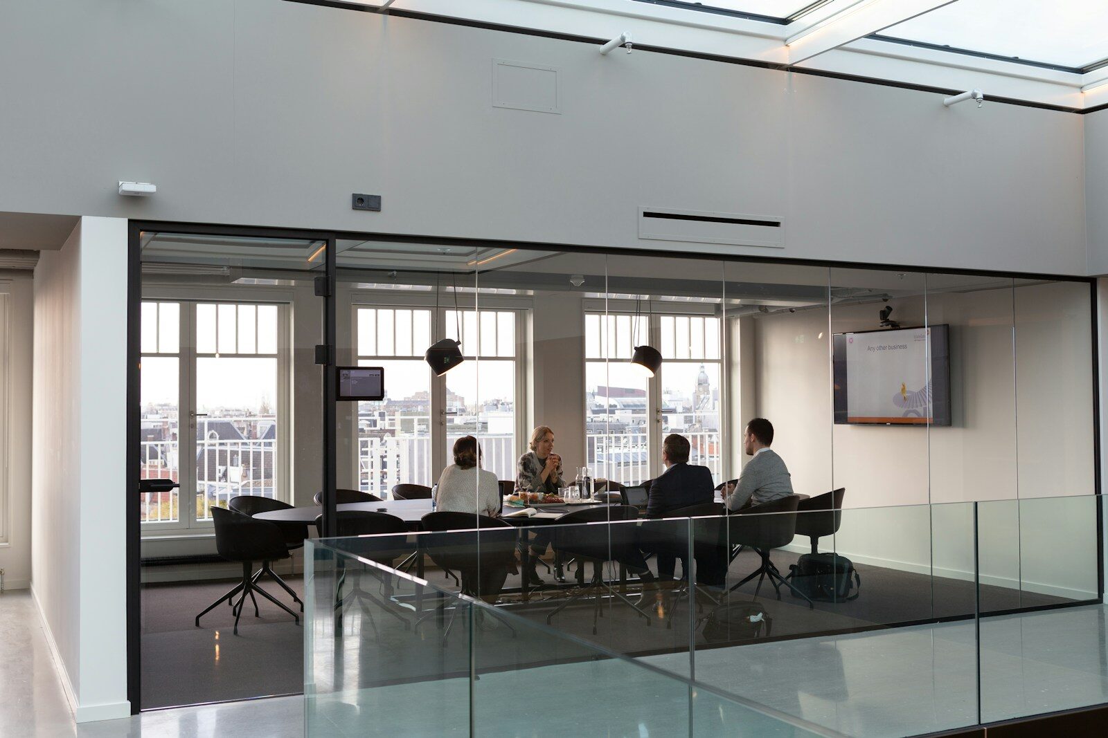Colleagues collaborating on a project in a meeting room, representing the visible stretch assignments that help enhance your career