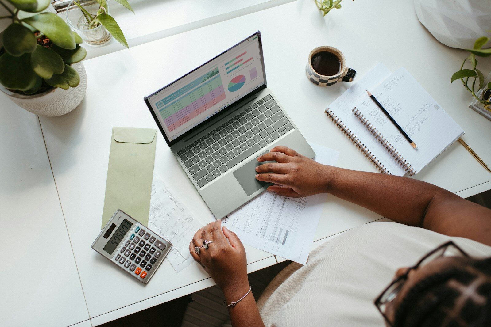 A person reviewing a salary schedule spreadsheet on a laptop, representing the pay research needed before signing a teaching contract
