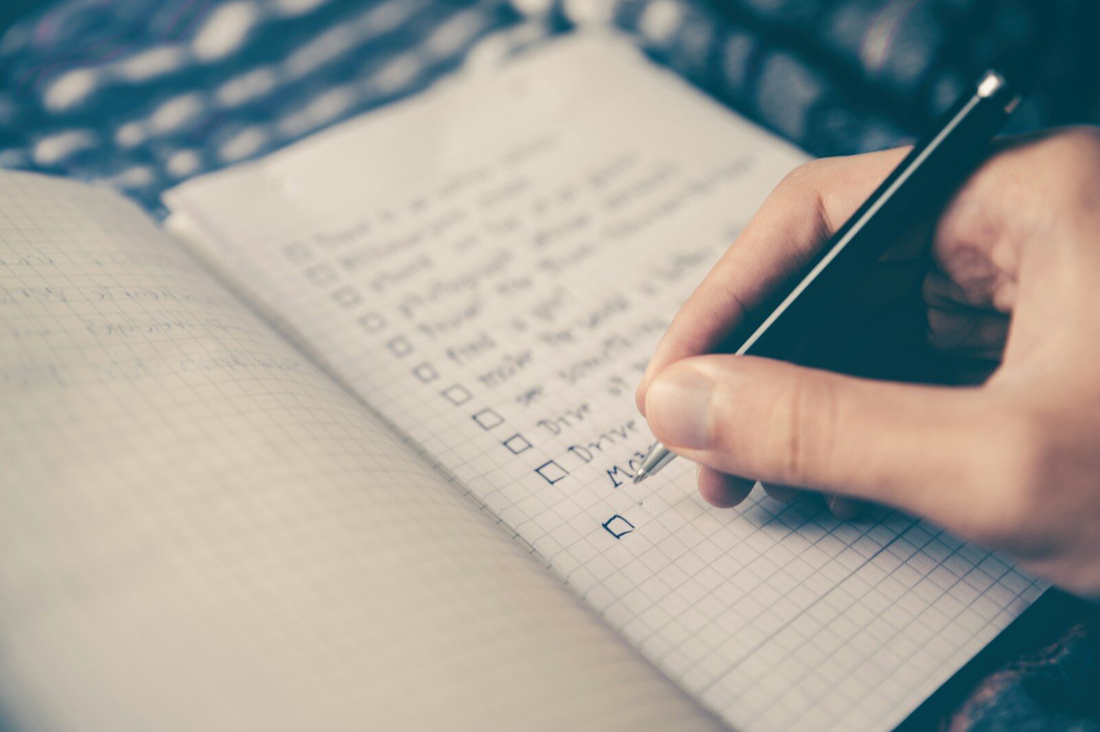 A person taking notes while on a phone call, representing the persuasion and communication skills appointment setter jobs require