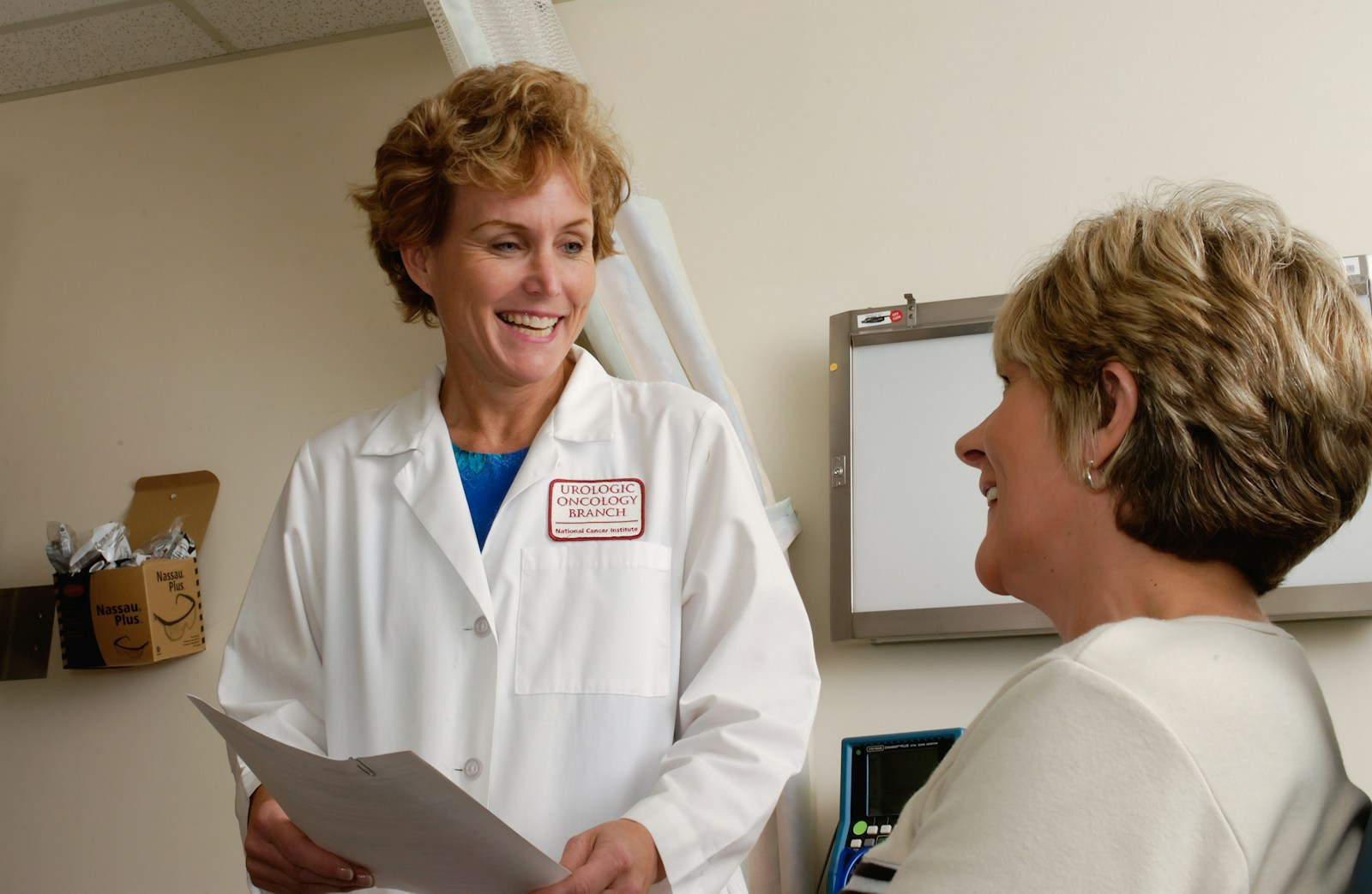 A nurse practitioner consulting with a patient in a clinic, illustrating the many benefits of a nursing career