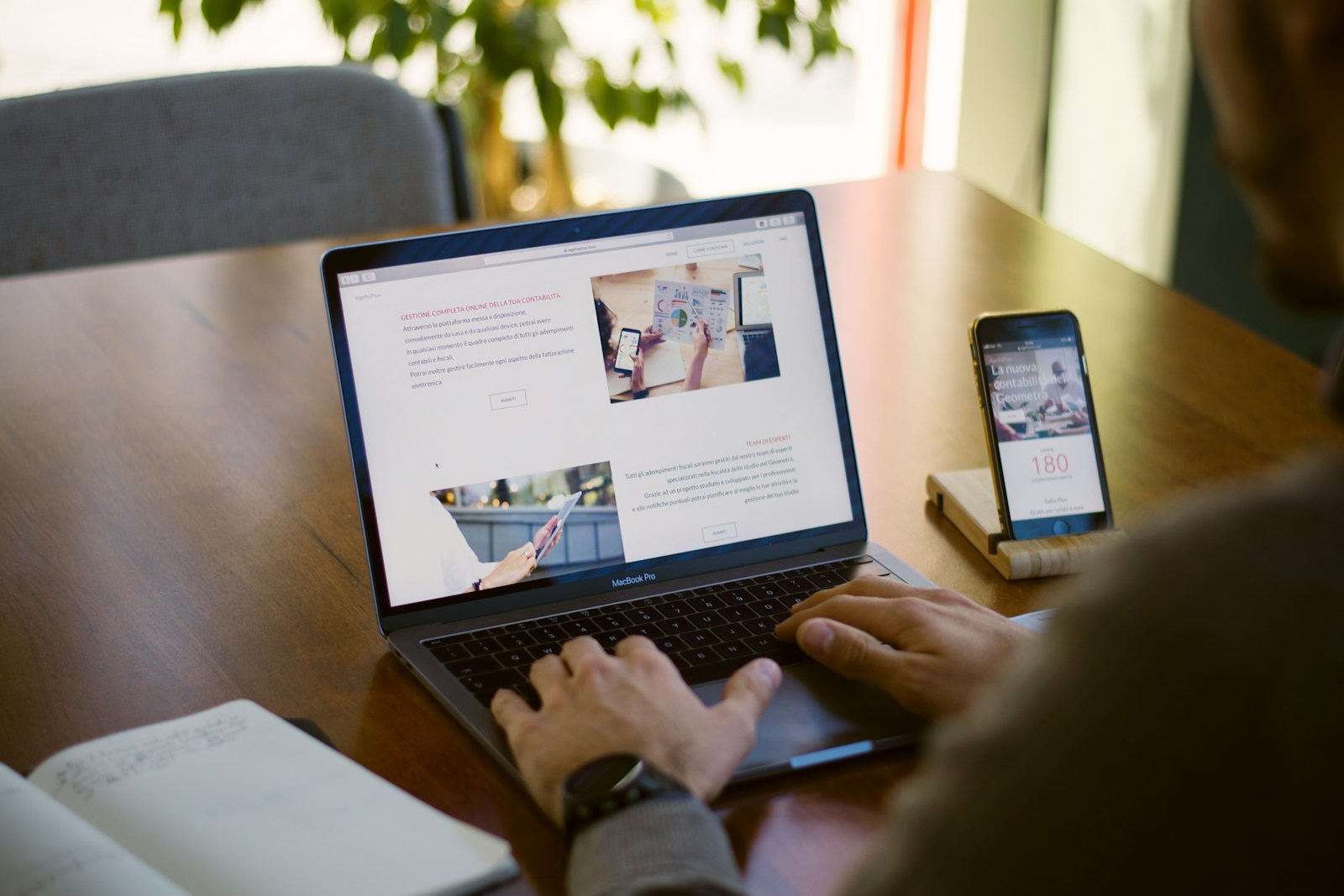 A person comparing job search websites on a laptop and phone, weighing the problem with Monster Jobs