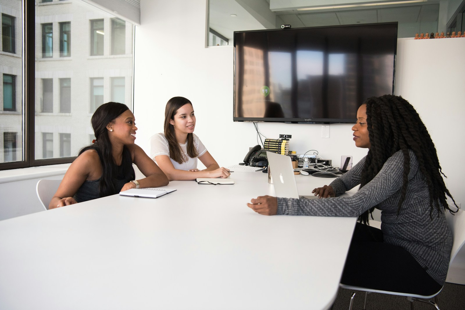 A hiring panel listening closely to a candidate during a job interview, illustrating the power of the spoken word