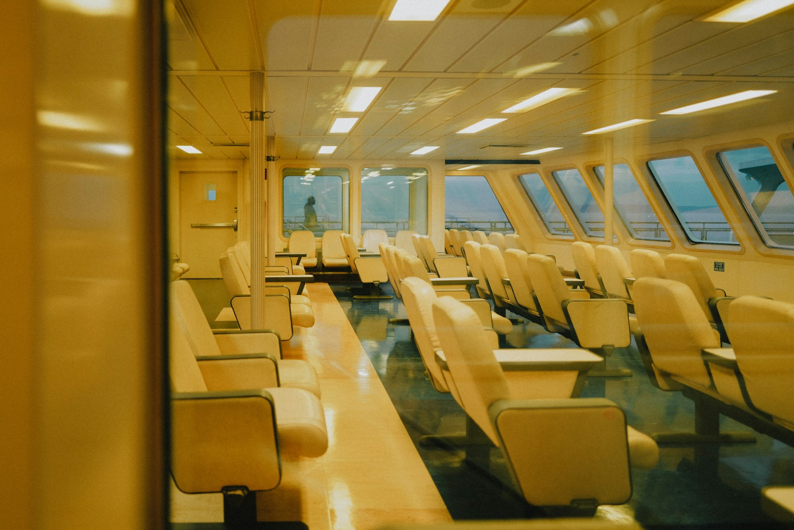 An aircraft cabin interior where a corporate flight attendant trains for emergency procedures