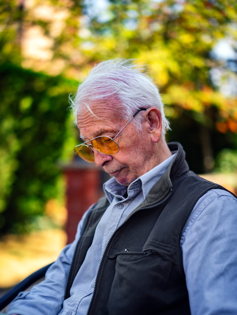 An older adult reflecting outdoors, representing purpose and meaning in retirement