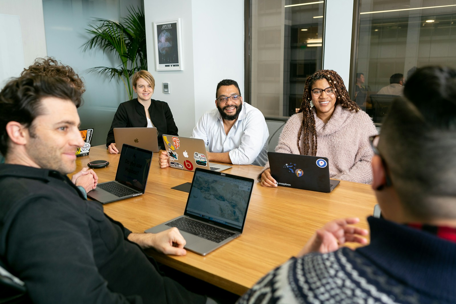 A diverse group of professionals in a meeting, representing the narrowing gender workforce participation gap tracked by the Indeed Hiring Lab